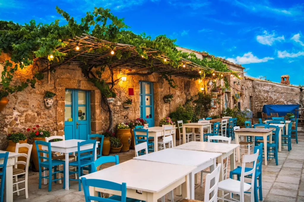 Famous colorful outdoor cafe in the most beautiful sicilian village Marzamemi in Sicily, south Italy