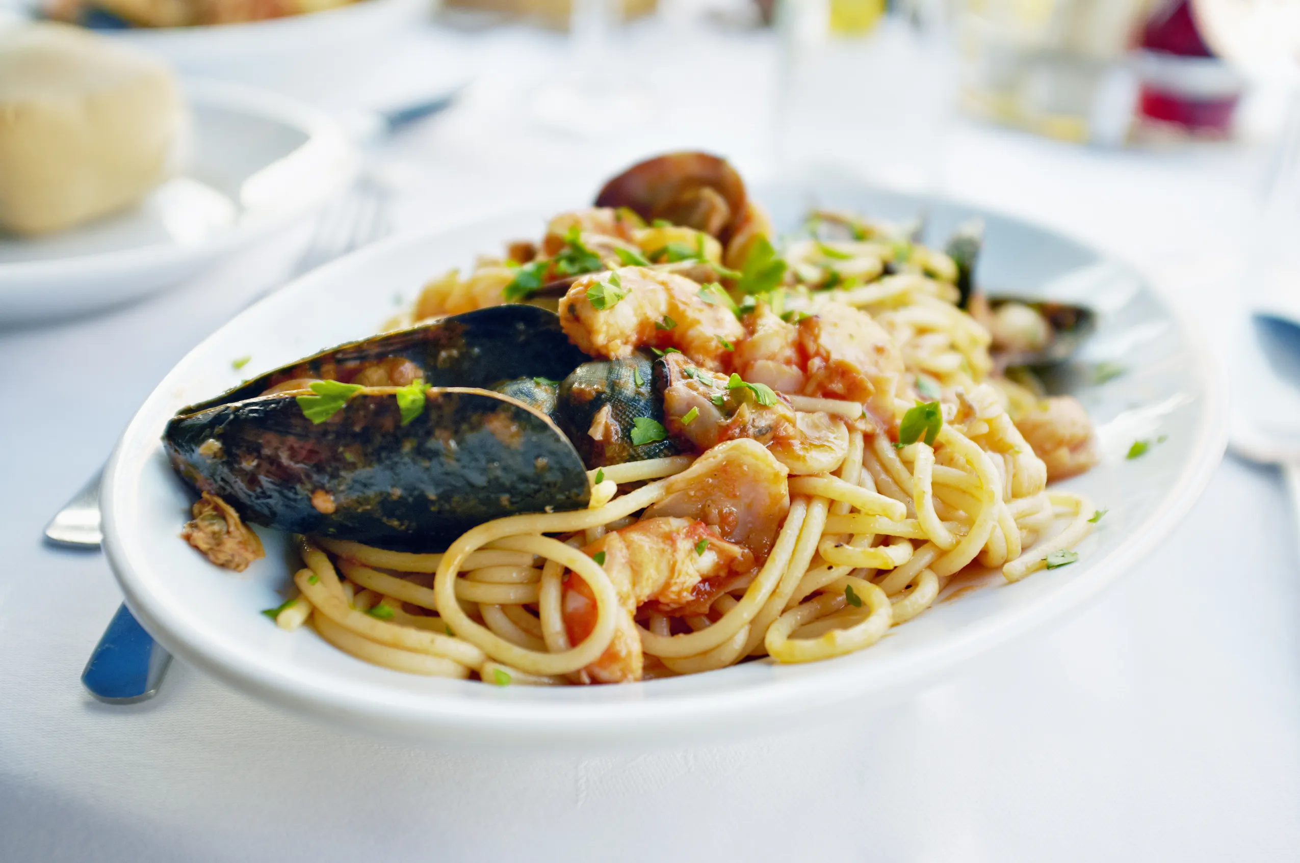Fresh Seafood pasta - Spaghetti, clams, shrimps and squid, served in a restaurant in Burano, Veneto, Italy.