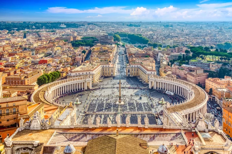 Famous Saint Peter's Square in Vatican and aerial view of the Rome city during sunny day.