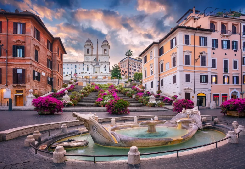 Cityscape image of Spanish Steps and Barcaccia Fountain in Rome, Italy at sunrise.
