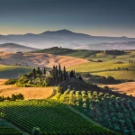 Scenic Tuscany landscape with rolling hills and valleys in golden morning light, Val d'Orcia, Italy