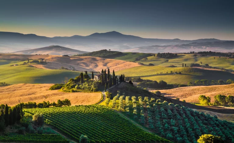 Scenic Tuscany landscape with rolling hills and valleys in golden morning light, Val d'Orcia, Italy