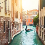 Beautiful canal with old medieval architecture in Venice, Italy. View of Grand Canal and gondola. Famous travel destination